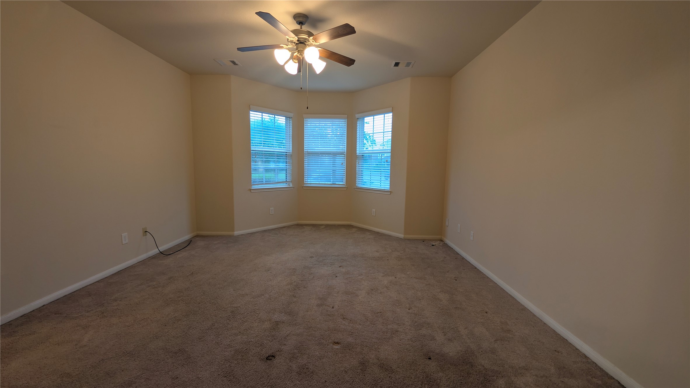 7326 Granite Terrace Lane Houston, TX 77083 - Photo 9 of 39 an empty room with a window and a fan