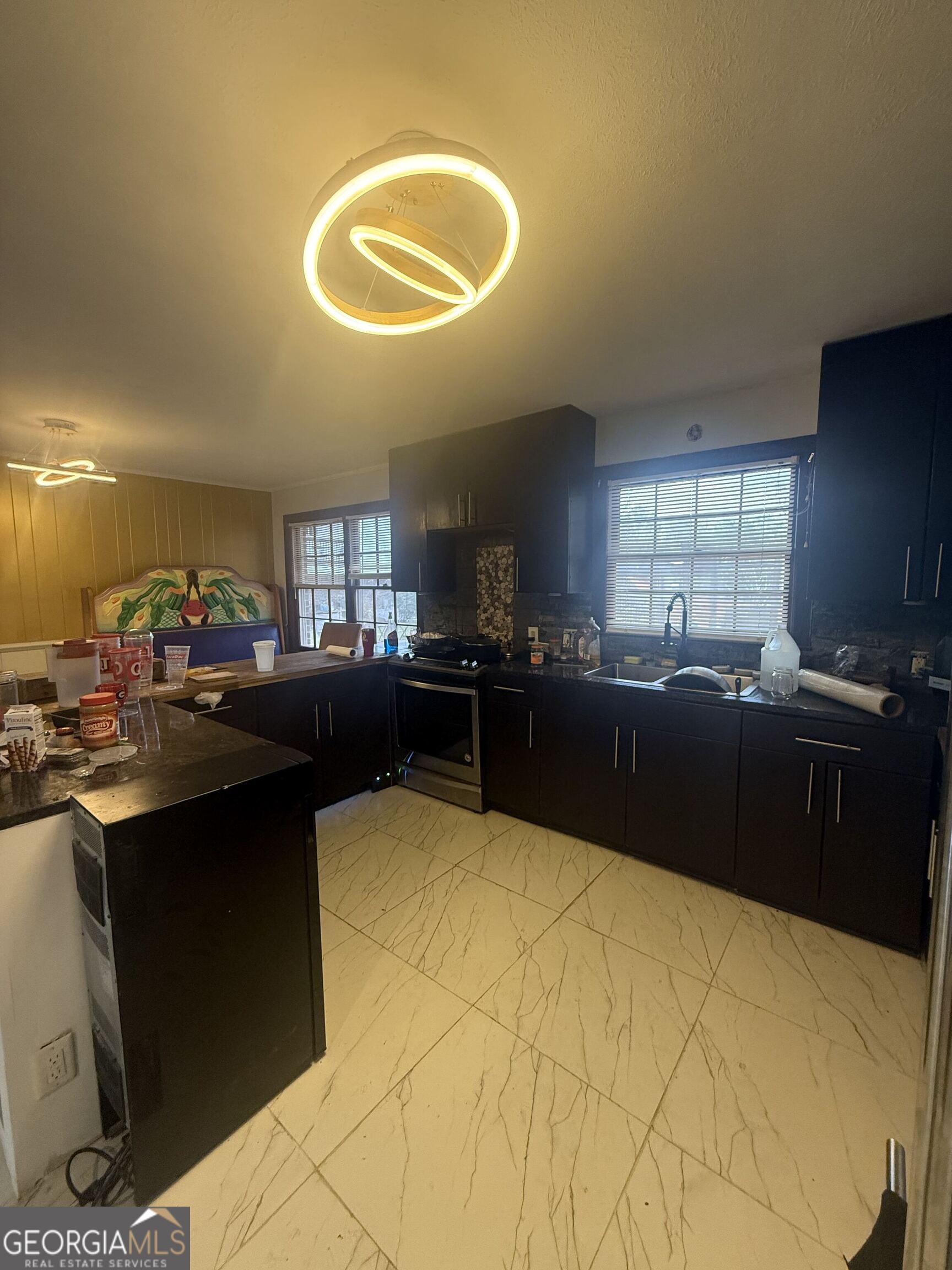 3861 Newnan Road Griffin, GA 30223 - Photo 34 of 89 a kitchen with granite countertop a sink cabinets and stainless steel appliances
