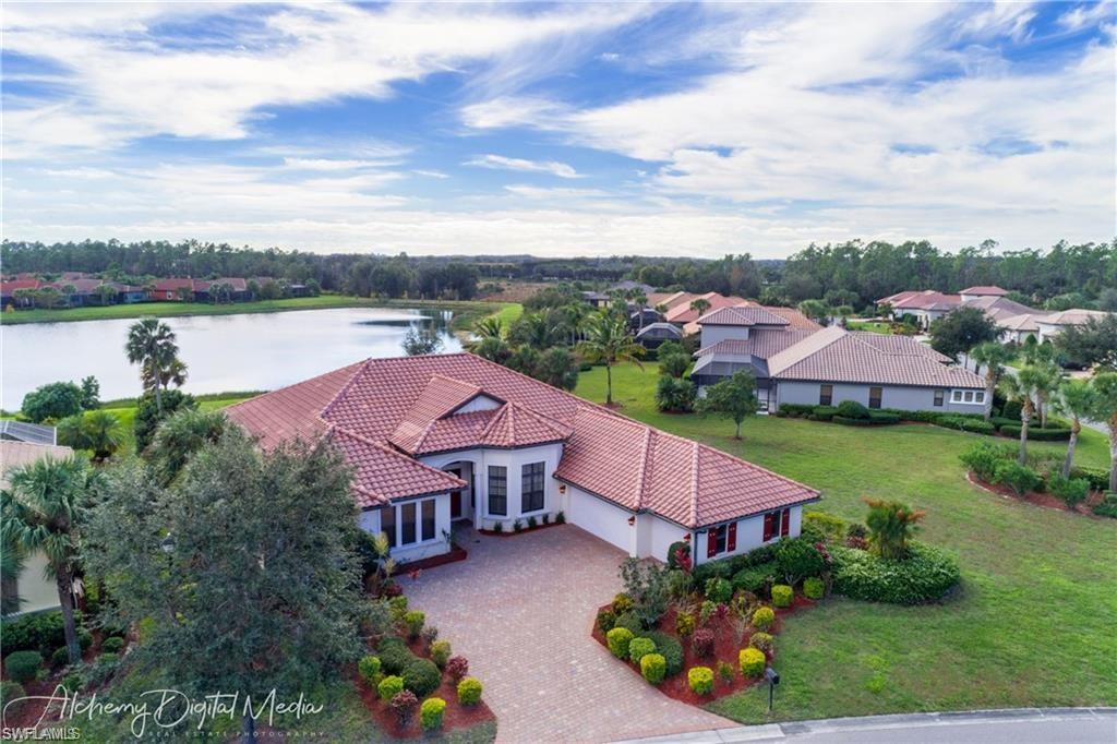 an aerial view of a house with outdoor space and lake view