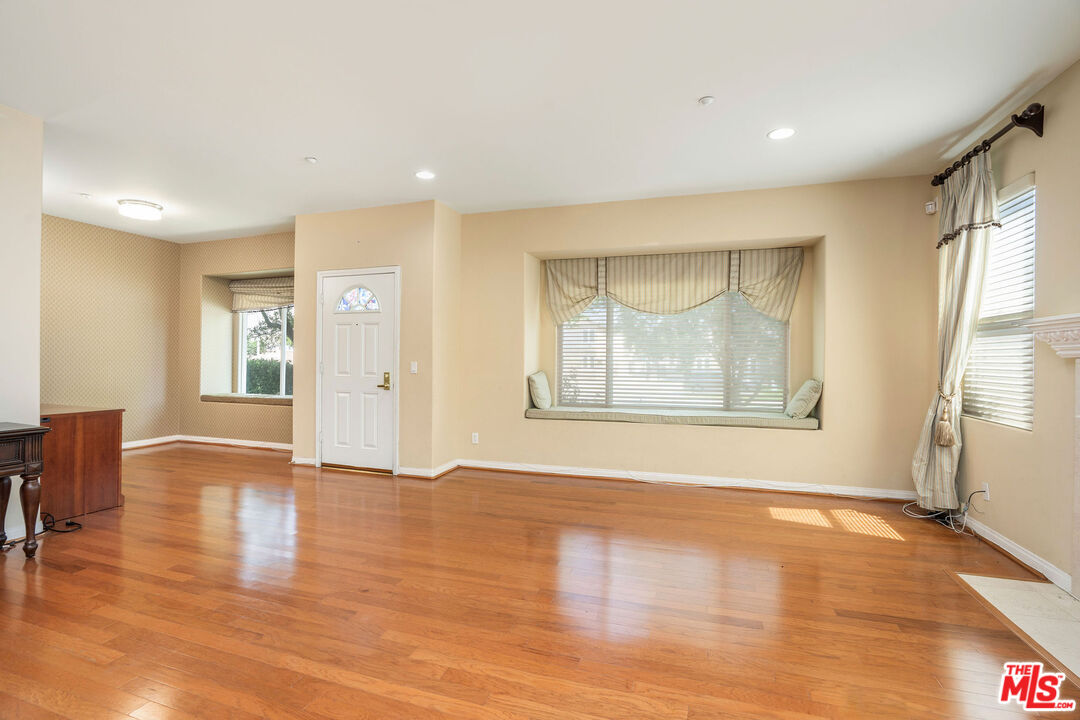 1128 West Duarte Road, Unit A Arcadia, CA 91007 - Photo 8 of 28 a view of an empty room with wooden floor and a window