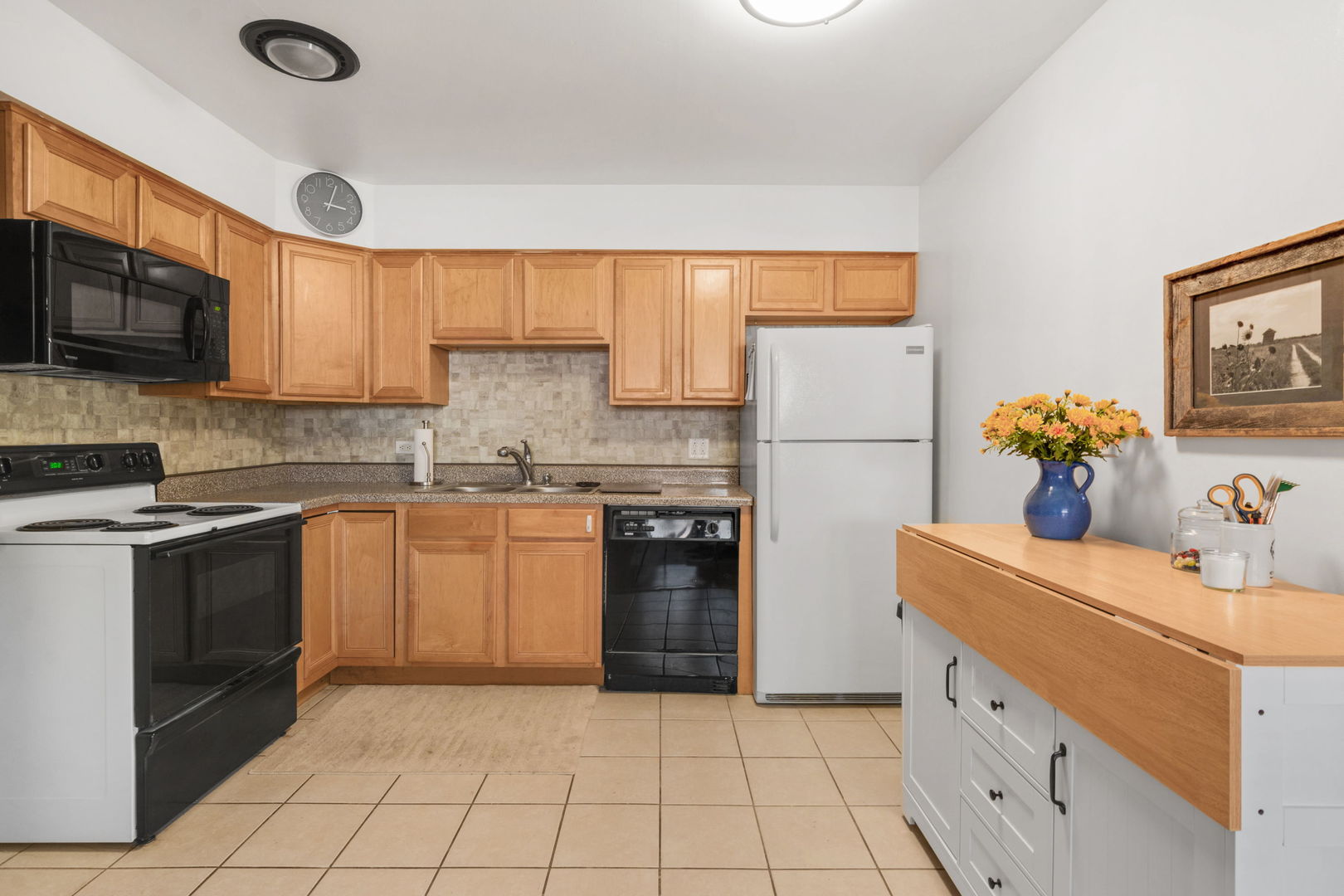 2141 Ridge Avenue, Unit 2B Evanston, IL 60201 - Photo 5 of 13 a kitchen with a sink cabinets and stainless steel appliances