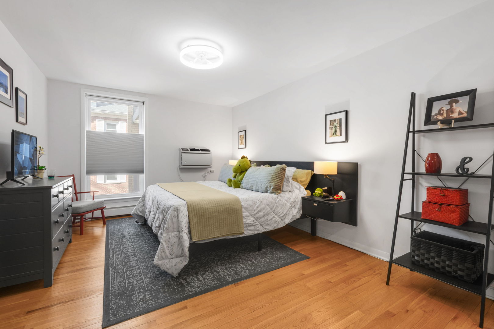 2141 Ridge Avenue, Unit 2B Evanston, IL 60201 - Photo 7 of 13 a bedroom with a bed and wooden floor