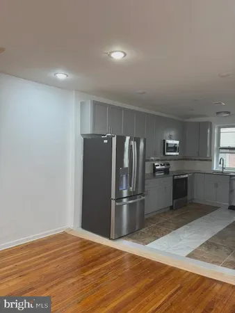 a kitchen with granite countertop a refrigerator and a sink