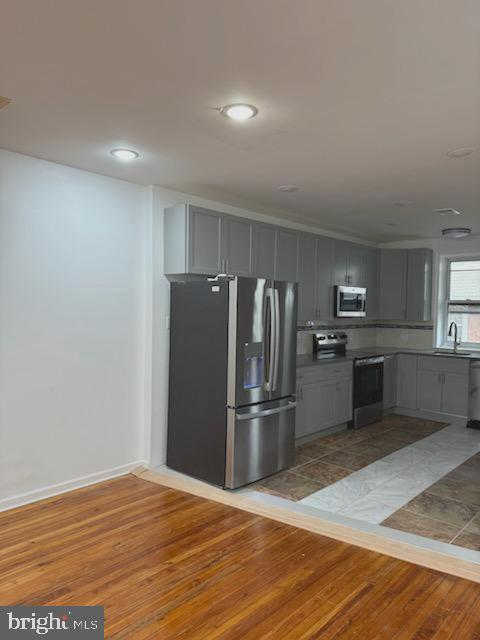 5817 Norfolk Street Philadelphia, PA 19143 - Photo 5 of 11 a kitchen with granite countertop a refrigerator and a sink