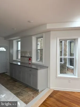 a kitchen with stainless steel appliances granite countertop a sink and cabinets with wooden floor
