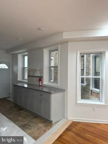 a kitchen with stainless steel appliances granite countertop a sink and cabinets with wooden floor
