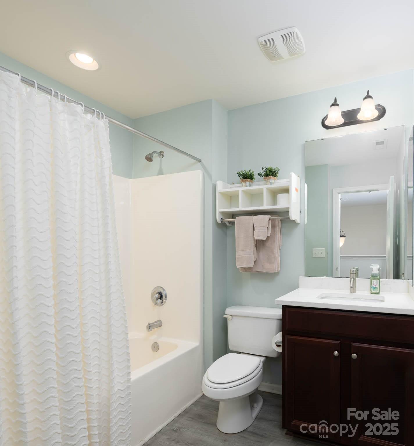 18547 The Commons Boulevard Cornelius, NC 28031 - Photo 19 of 33 a bathroom with a sink vanity mirror and toilet