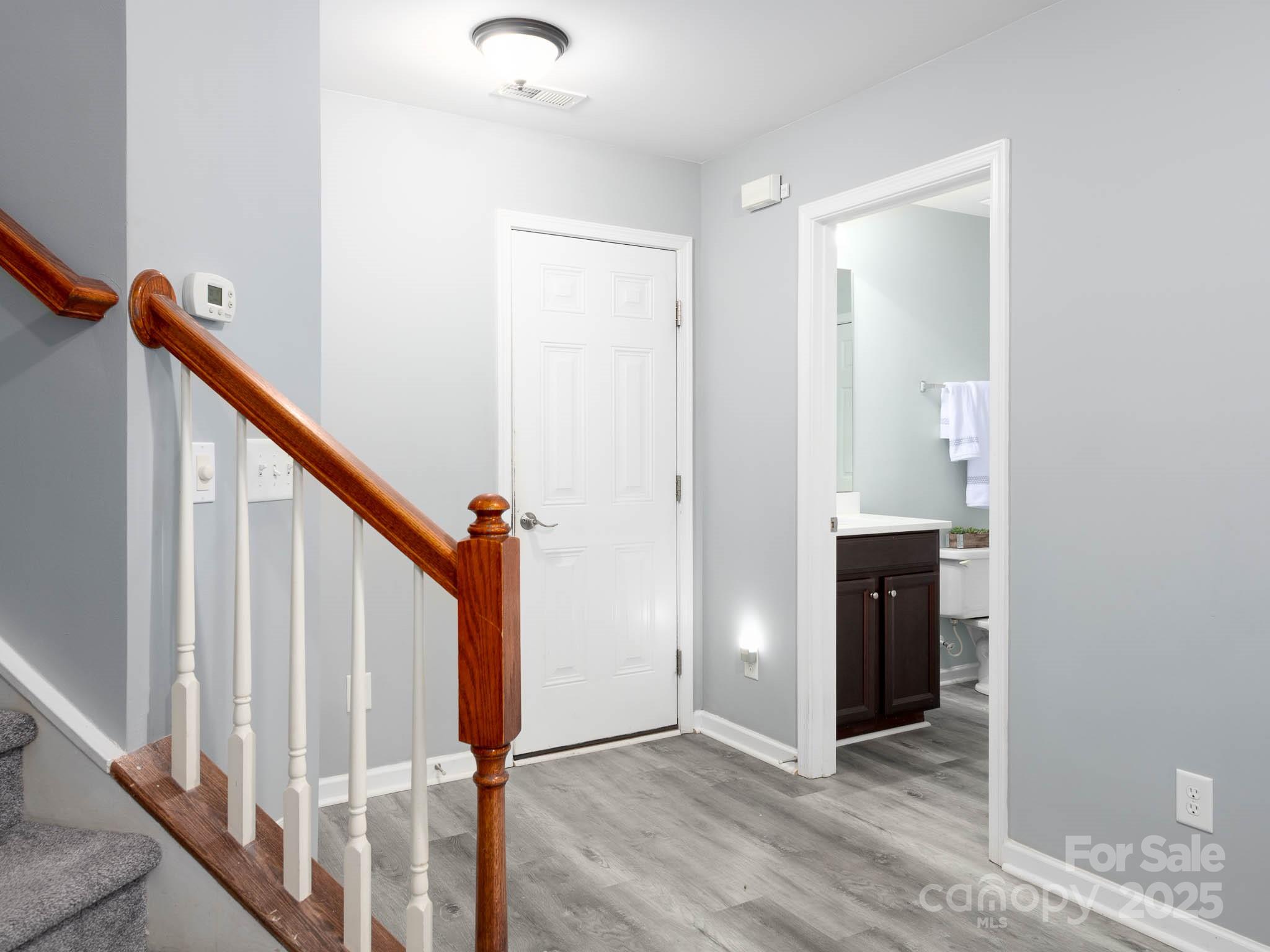 18547 The Commons Boulevard Cornelius, NC 28031 - Photo 26 of 33 a view of an entryway with wooden floor and staircase