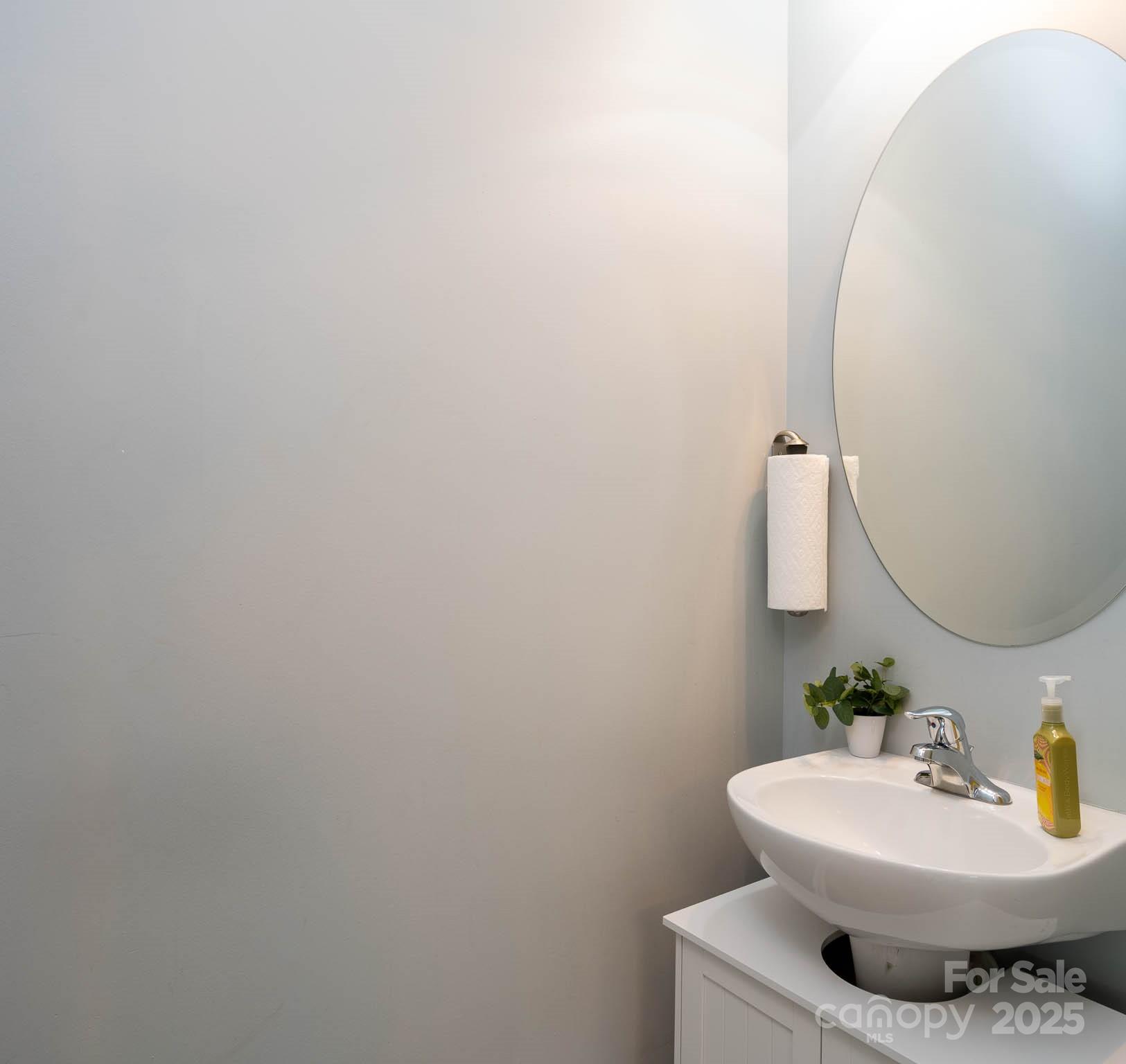 18547 The Commons Boulevard Cornelius, NC 28031 - Photo 10 of 33 a bathroom with a sink and a mirror
