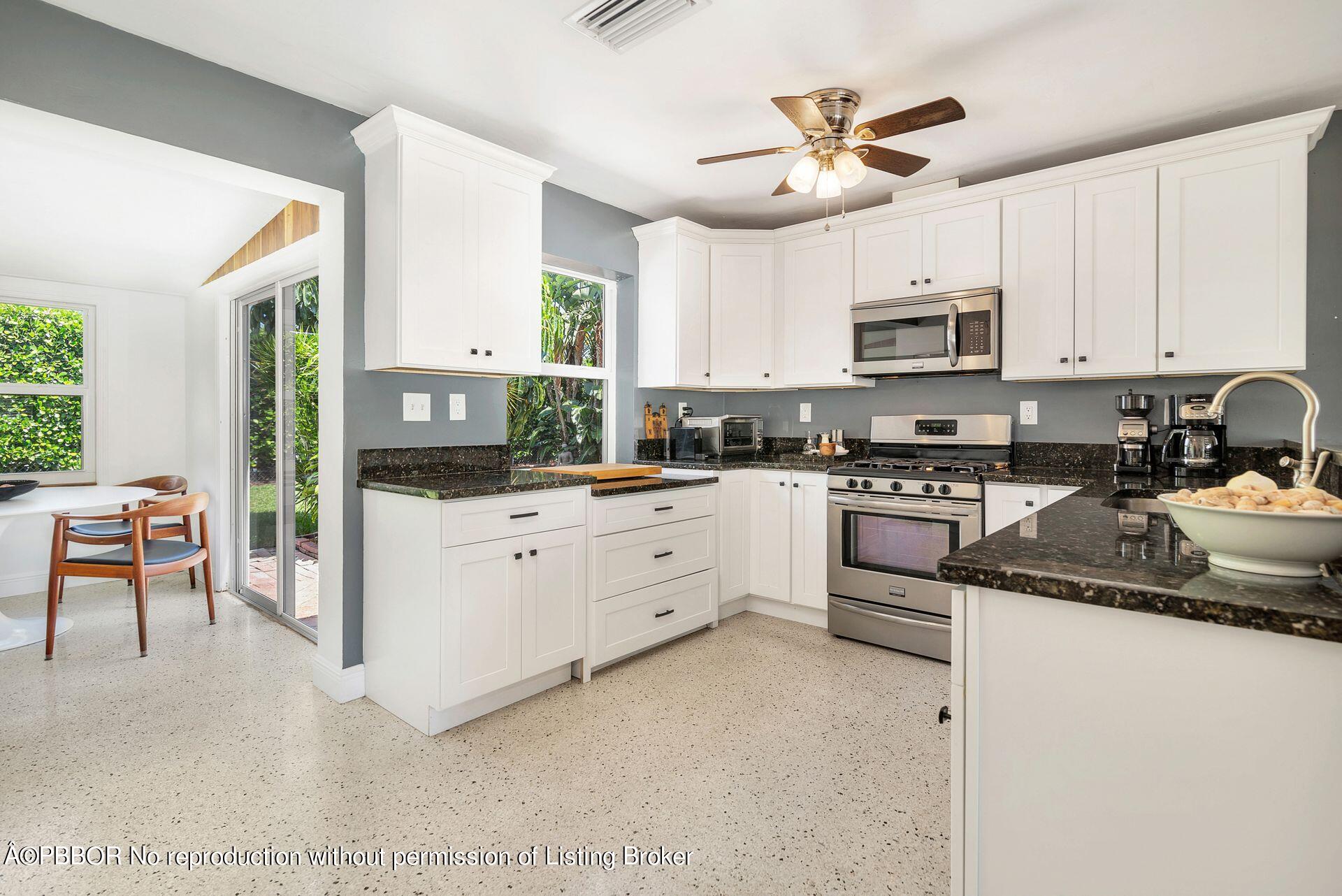 173 Arlington Road West Palm Beach, FL 33405 - Photo 11 of 27 a kitchen with white cabinets and white appliances