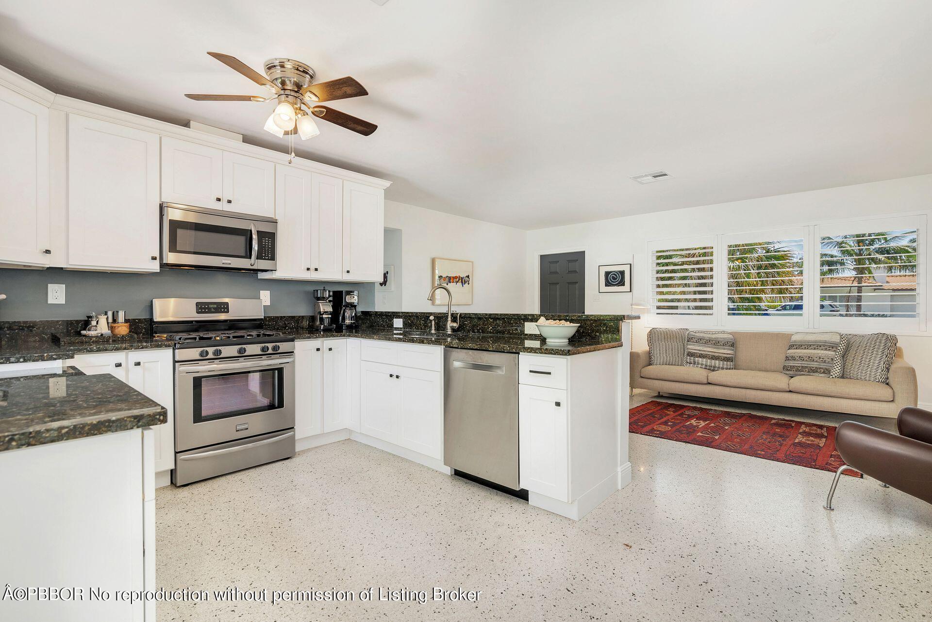 173 Arlington Road West Palm Beach, FL 33405 - Photo 14 of 27 a kitchen with stainless steel appliances white cabinets and a sink