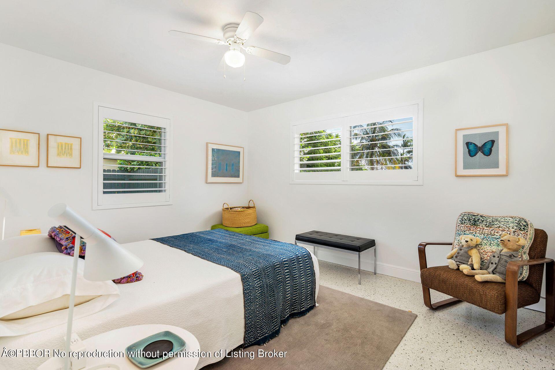 173 Arlington Road West Palm Beach, FL 33405 - Photo 18 of 27 a bedroom with a bed and a chandelier