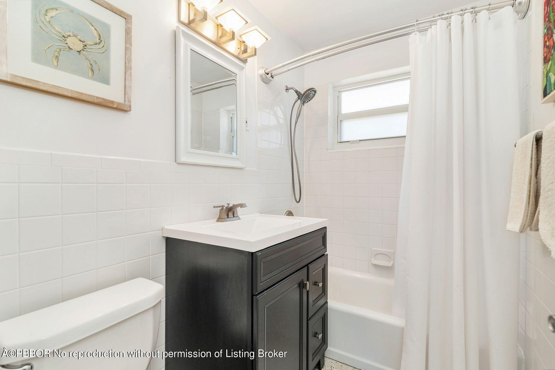 173 Arlington Road West Palm Beach, FL 33405 - Photo 19 of 27 a bathroom with a sink toilet and vanity
