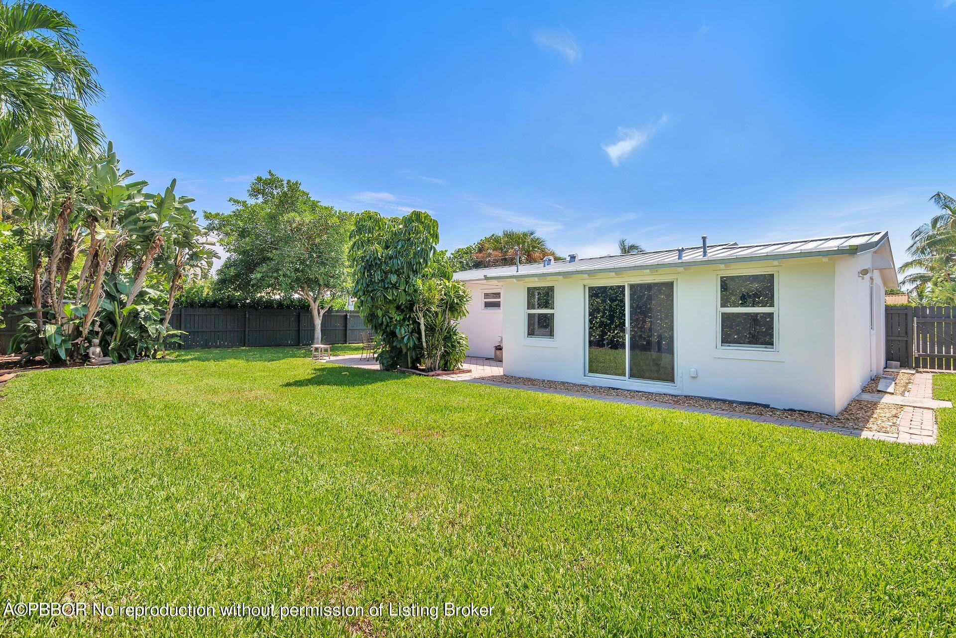 173 Arlington Road West Palm Beach, FL 33405 - Photo 25 of 27 a front view of a house with a garden and yard