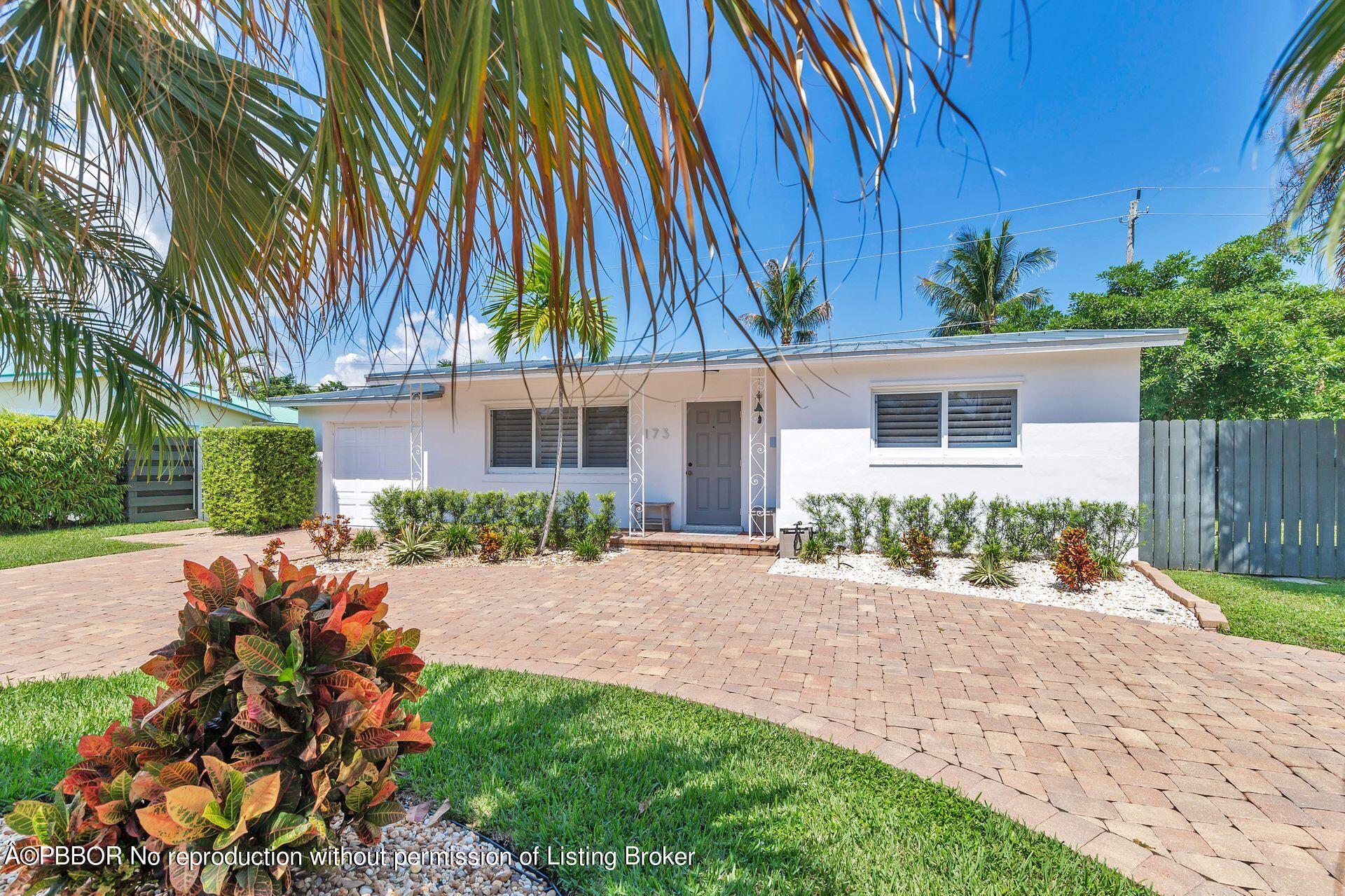 173 Arlington Road West Palm Beach, FL 33405 - Photo 5 of 27 front view of house with a yard and potted plants