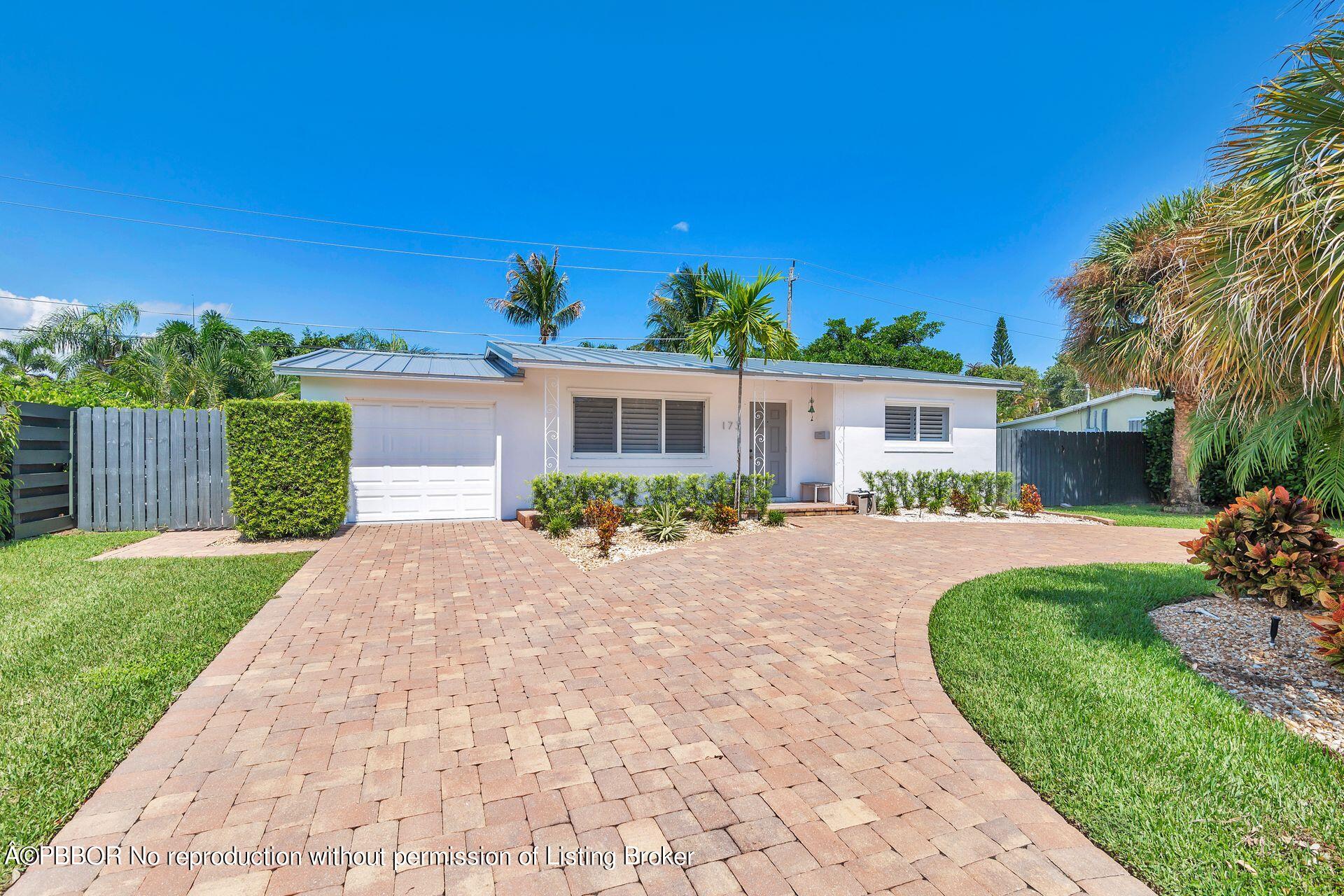 173 Arlington Road West Palm Beach, FL 33405 - Photo 6 of 27 a front view of a house with a yard and potted plants