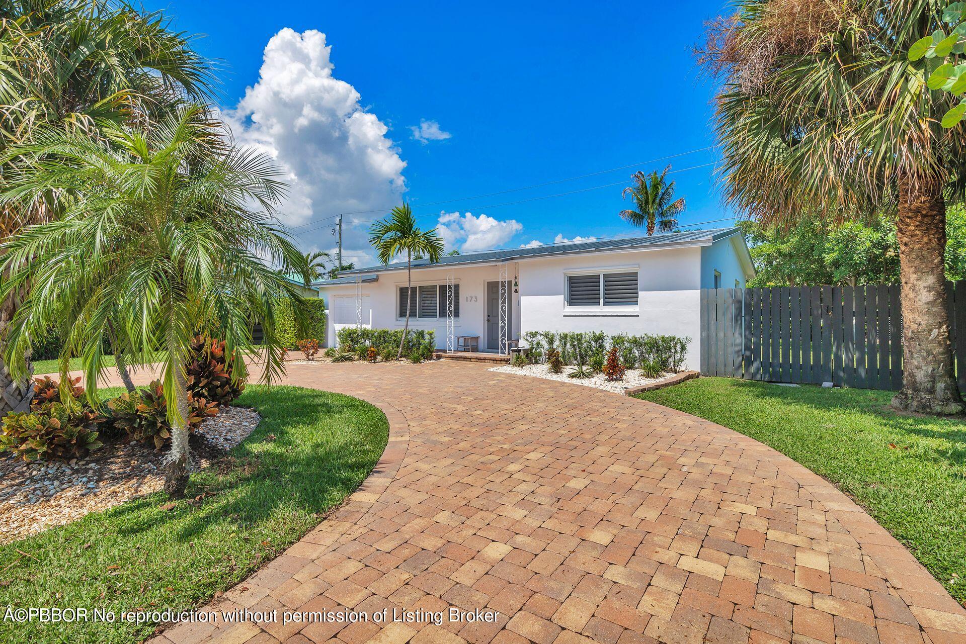 173 Arlington Road West Palm Beach, FL 33405 - Photo 7 of 27 a front view of a house with garden