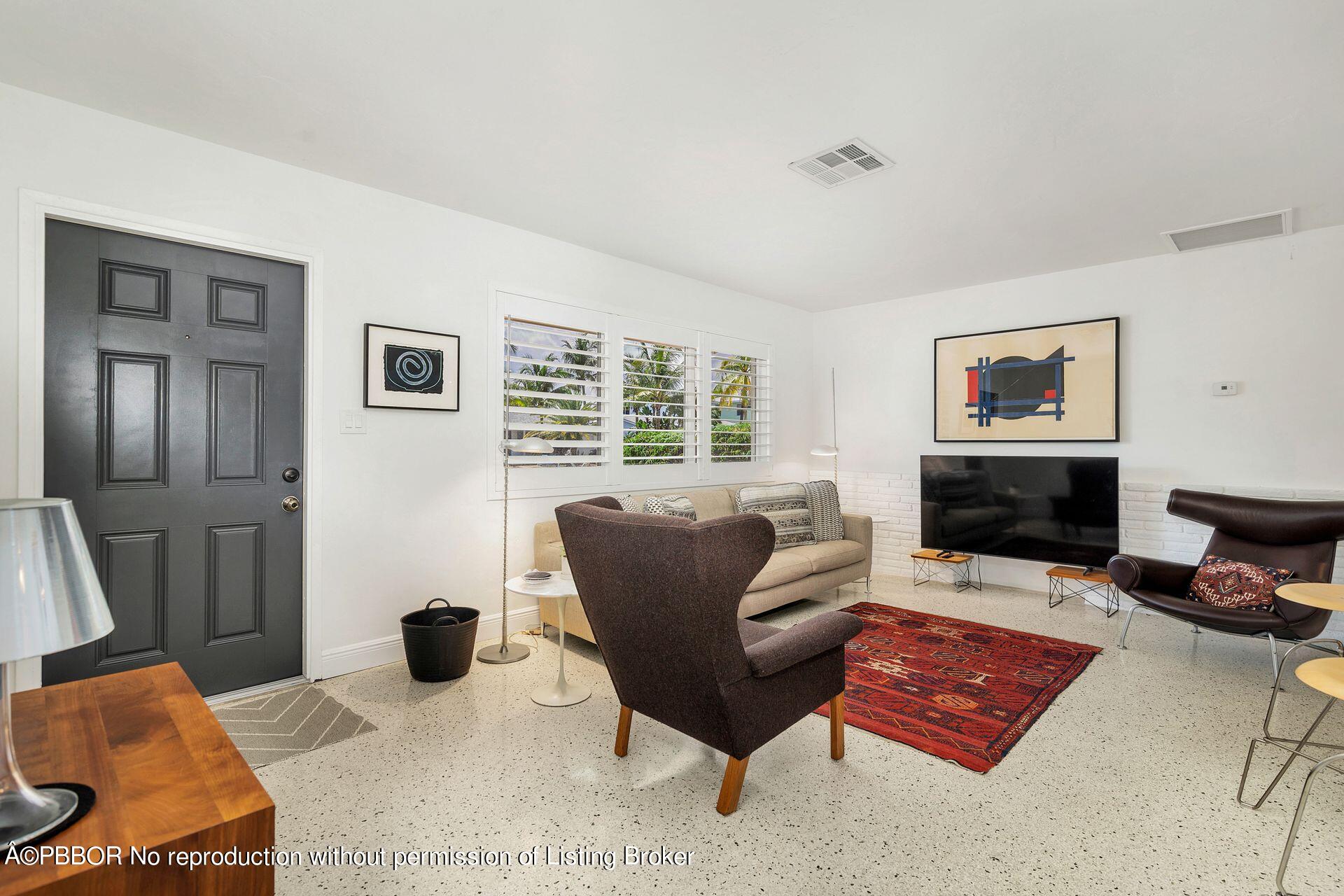 173 Arlington Road West Palm Beach, FL 33405 - Photo 8 of 27 a living room with furniture a rug and a window