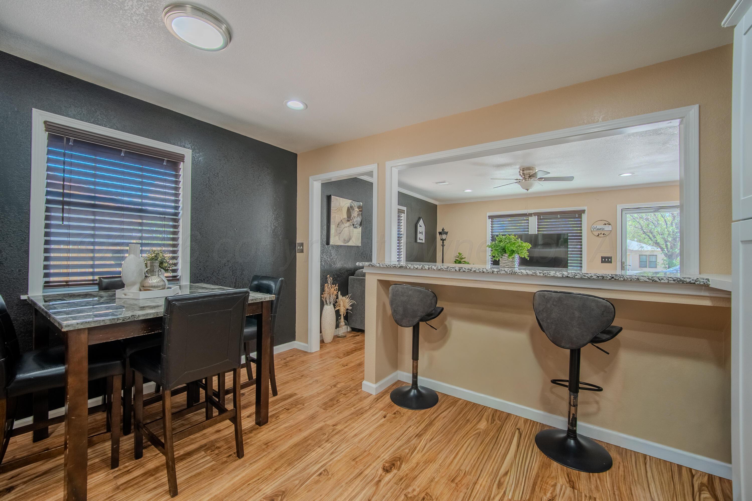 4014 Gables Street Amarillo, TX 79110 - Photo 4 of 14 a view of a dining room with furniture and wooden floor