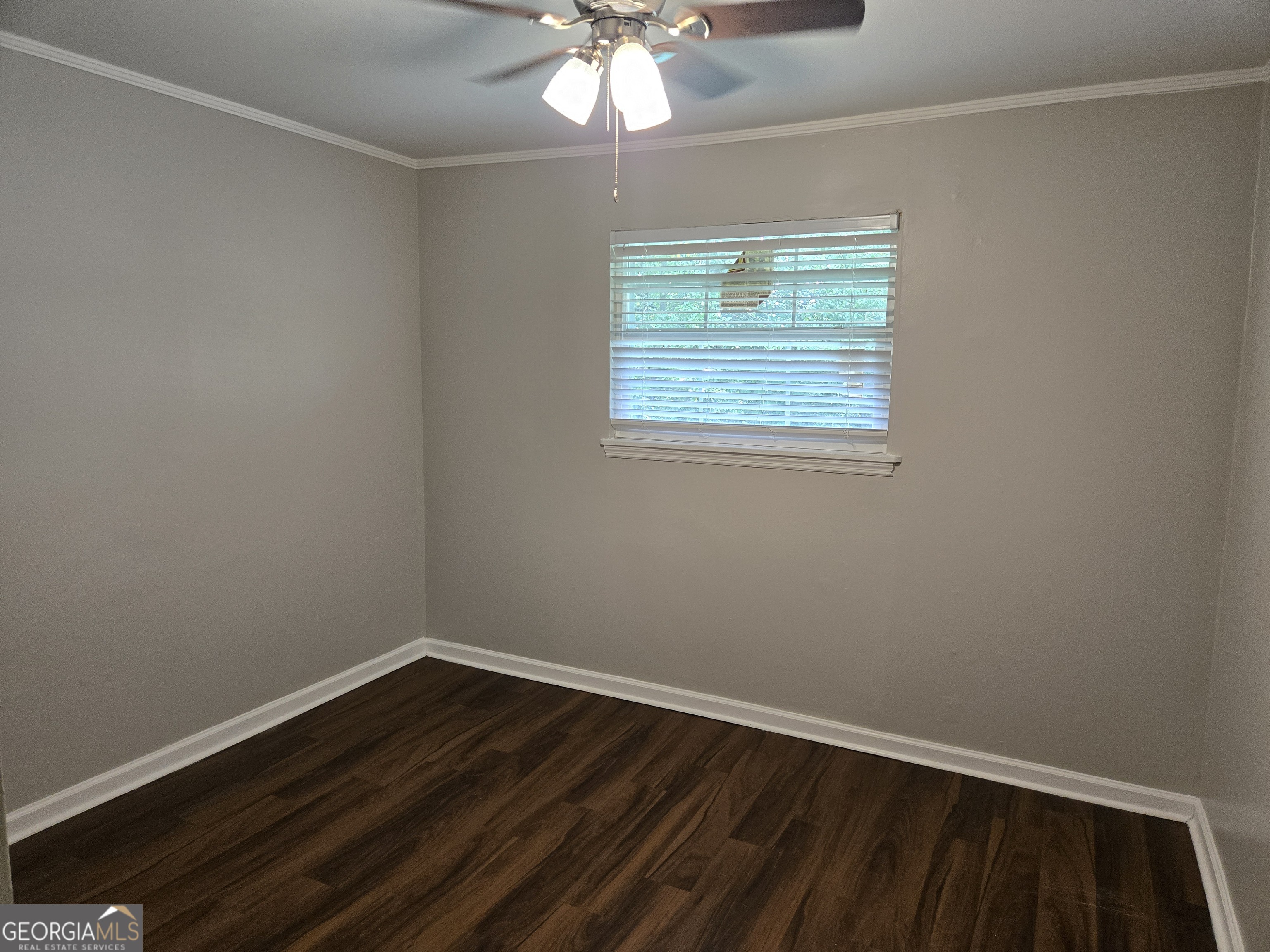 101 King Street Fort Valley, GA 31030 - Photo 14 of 17 a view of an empty room with wooden floor and a window