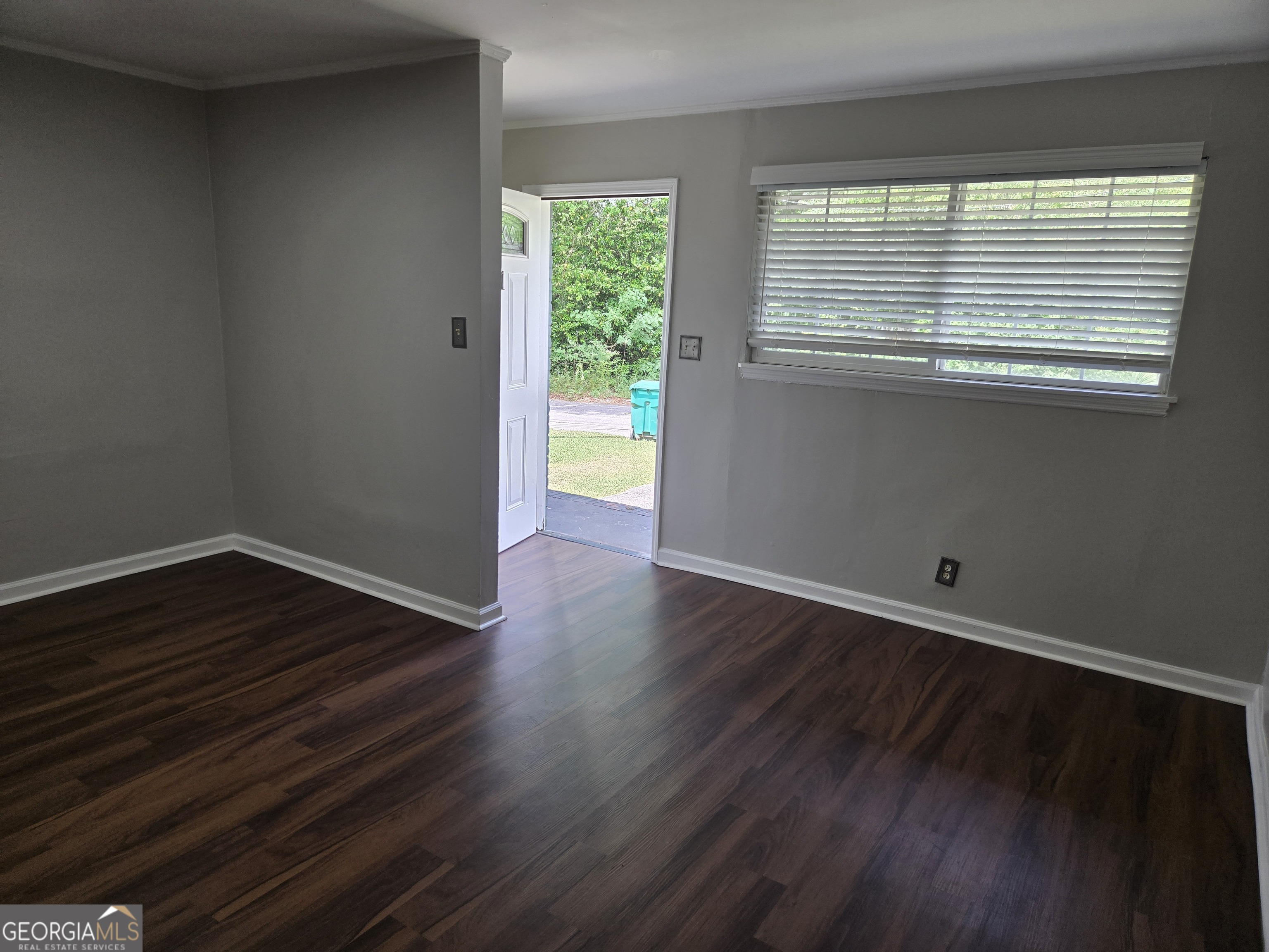 101 King Street Fort Valley, GA 31030 - Photo 15 of 17 a view of an empty room with wooden floor and a window