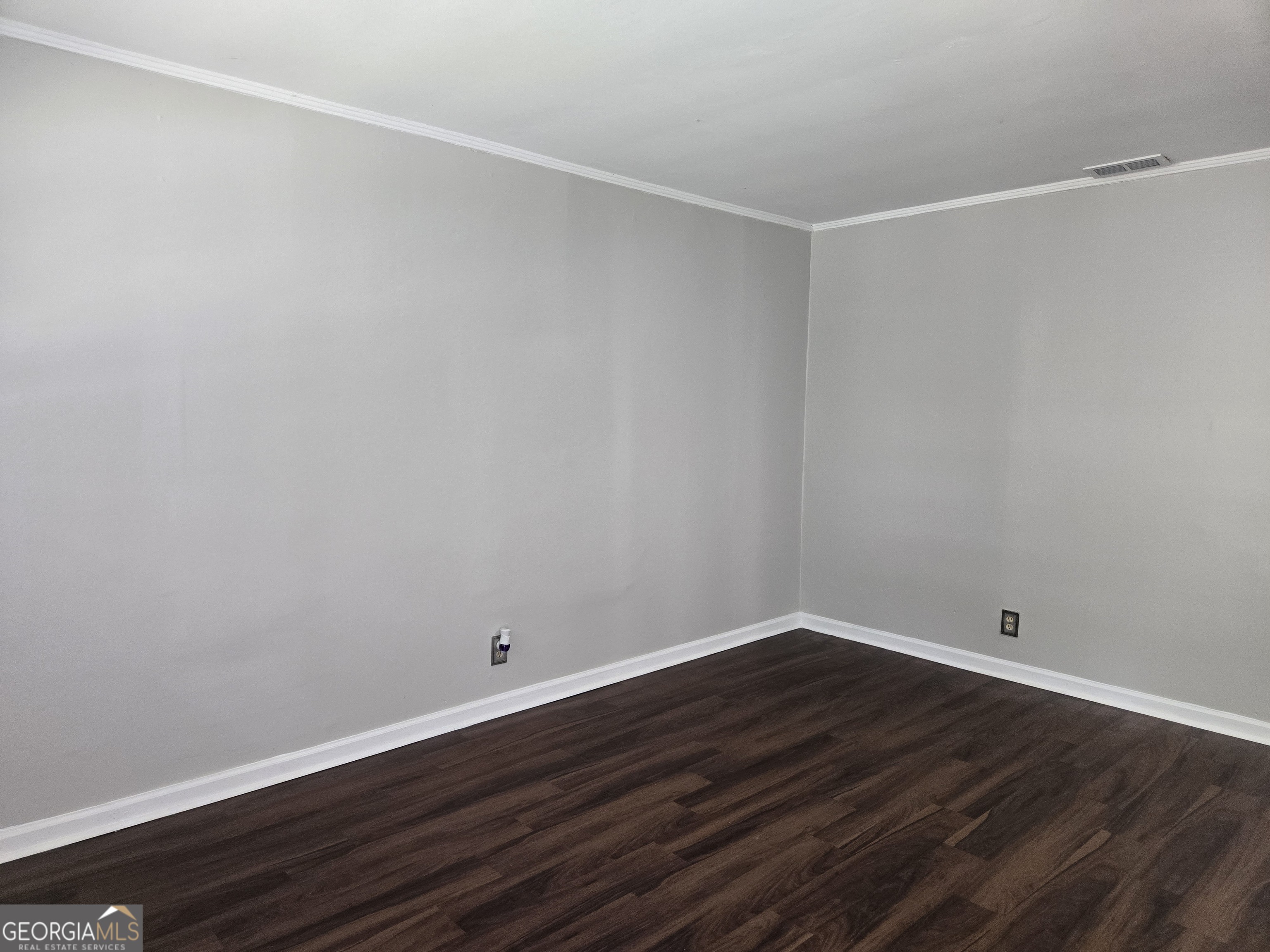 101 King Street Fort Valley, GA 31030 - Photo 8 of 17 a view of an empty room with wooden floor