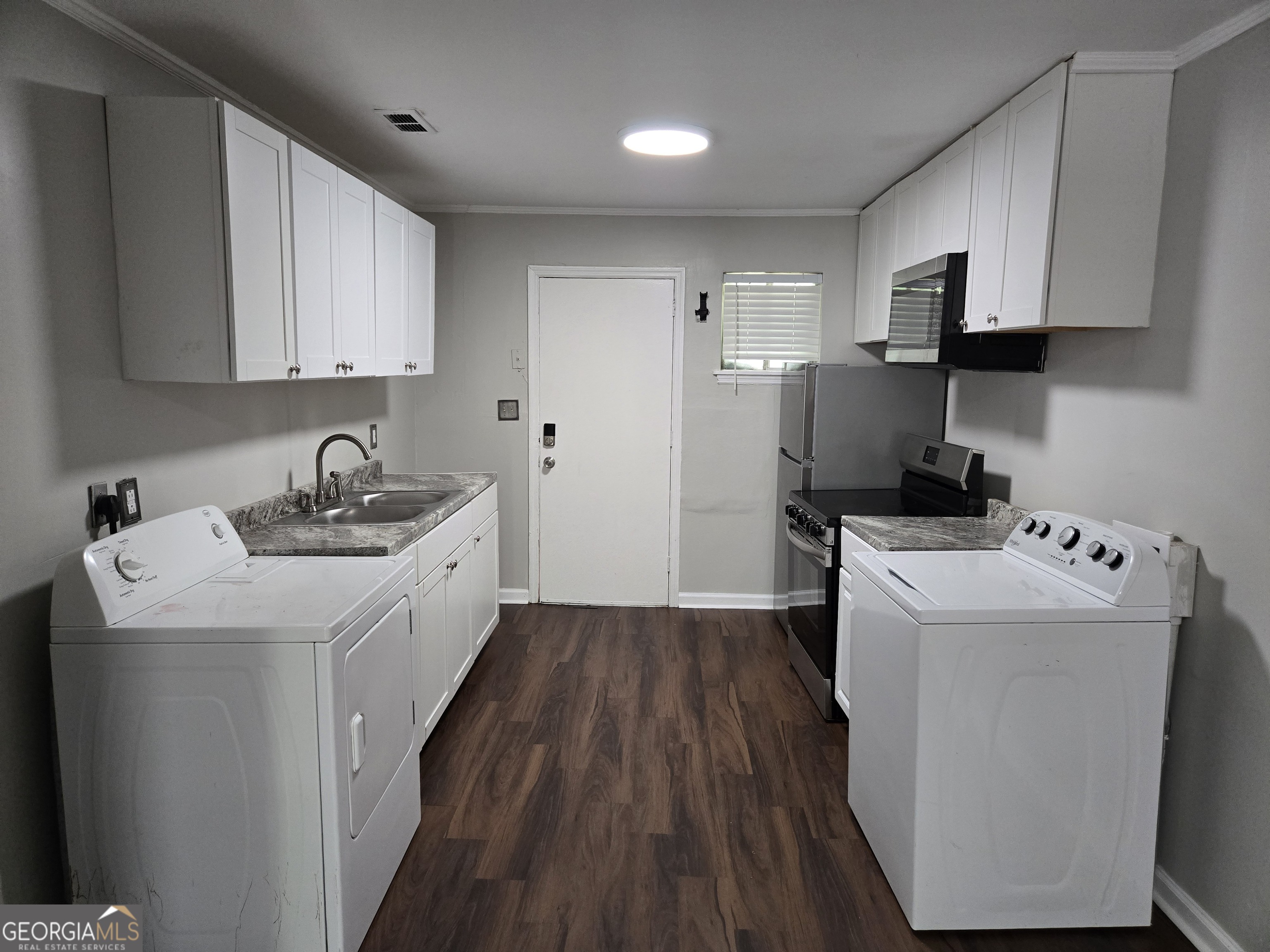 101 King Street Fort Valley, GA 31030 - Photo 10 of 17 a kitchen with a sink a stove and refrigerator