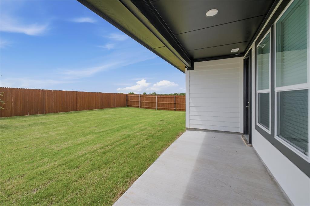 1325 Frio Drive Springtown, TX 76082 - Photo 20 of 24 Expansive backyard featuring a lush lawn, solid wood privacy fencing, and a concrete patio