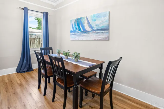 a view of a dining room with furniture and wooden floor