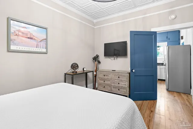 a bedroom with a bed and a flat screen tv