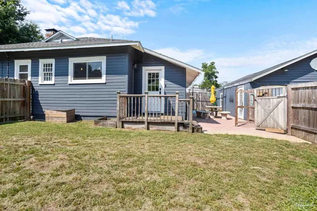 a house view with a sitting space and garden