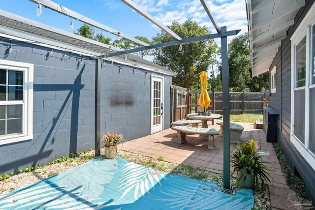a view of a patio with couches table and chairs and potted plants