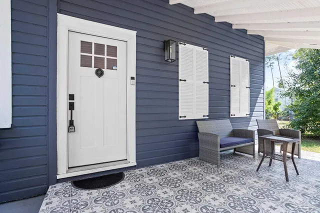 a view of a backyard with a chair and a potted plant