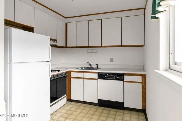 a kitchen with stainless steel appliances granite countertop a refrigerator a stove a sink and a microwave