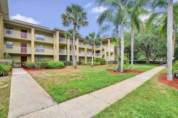 a front view of a residential apartment building with a yard