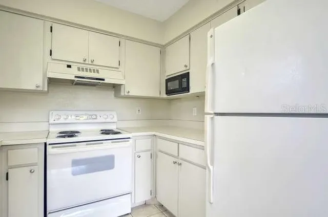 a kitchen with stainless steel appliances white cabinets and a sink