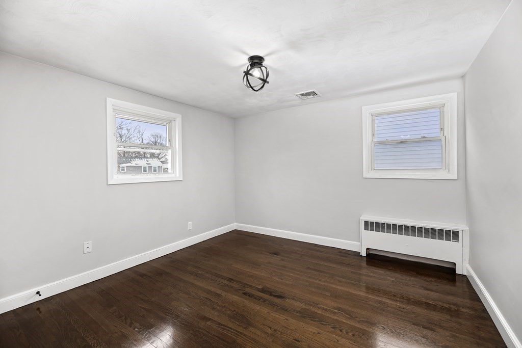 40 Como Road Boston, MA 02136 - Photo 17 of 31 a view of a room with wooden floor ceiling fan and windows