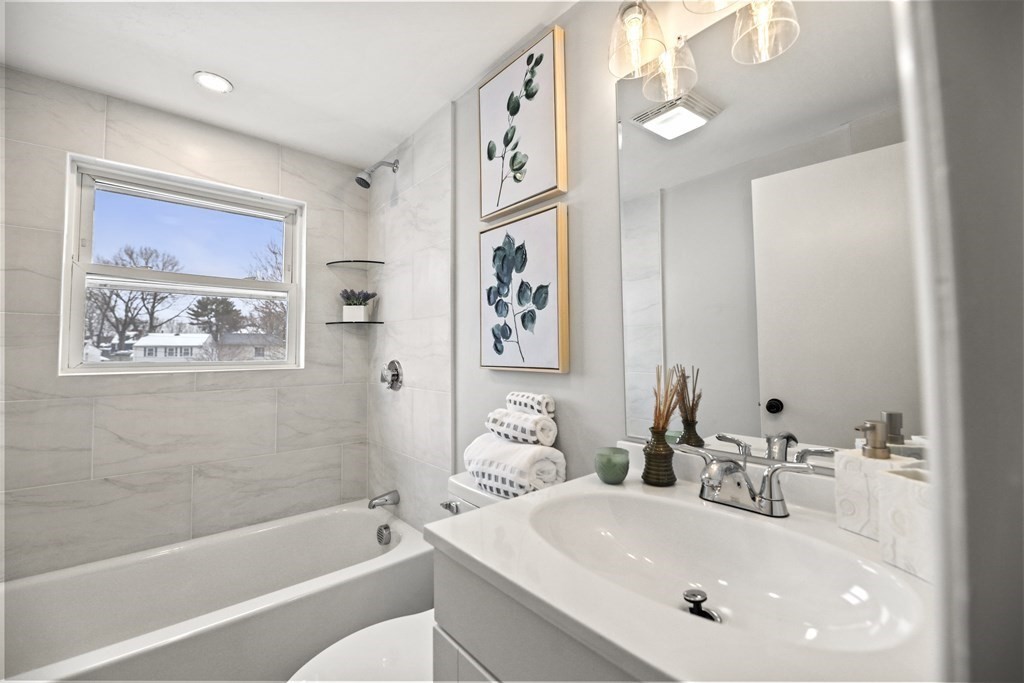 40 Como Road Boston, MA 02136 - Photo 21 of 31 a bathroom with a sink a large mirror and a bathtub