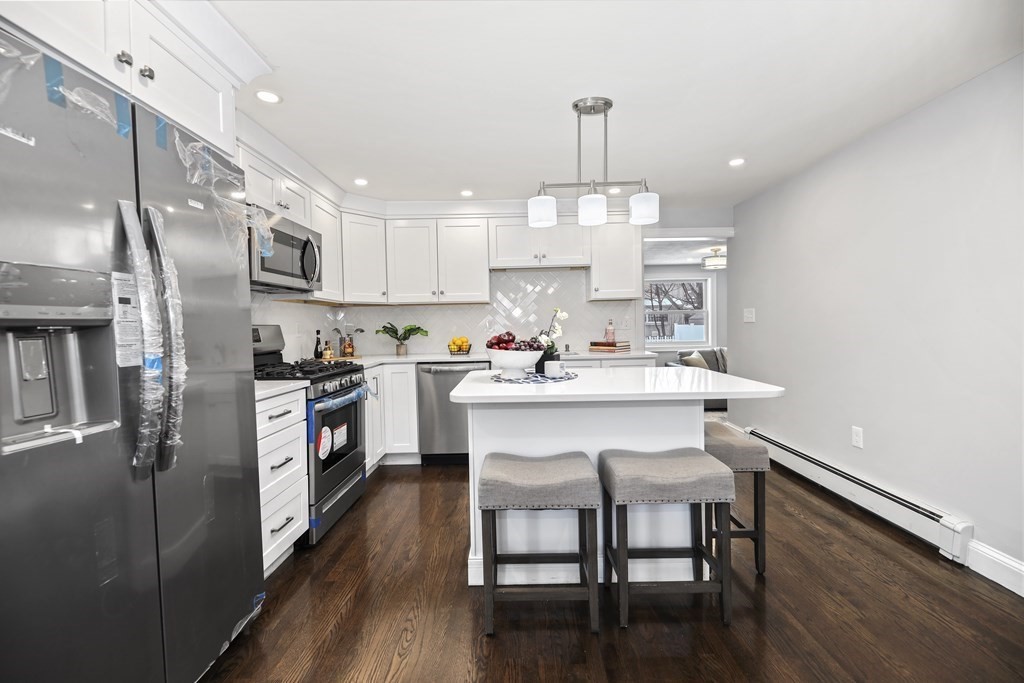 40 Como Road Boston, MA 02136 - Photo 7 of 31 a kitchen with kitchen island stainless steel appliances a sink and cabinets