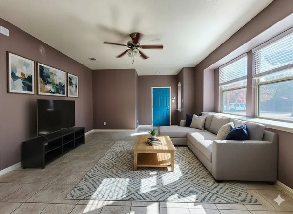 a view of livingroom with hardwood floor and a ceiling fan