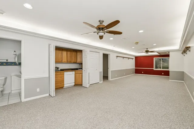a view of a kitchen with a sink and a refrigerator