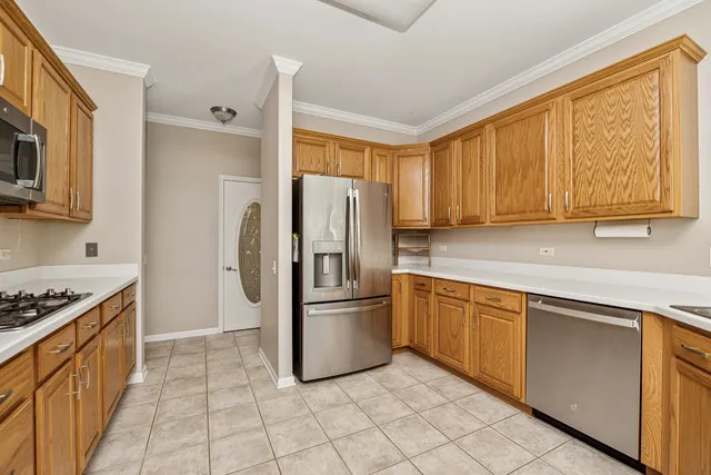 a kitchen with stainless steel appliances granite countertop a refrigerator stove top oven and sink