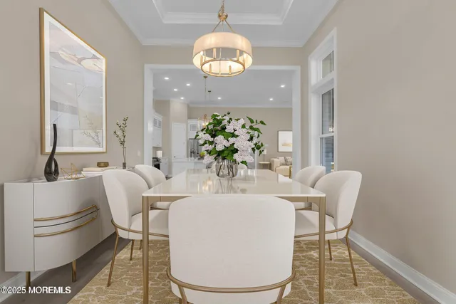 a dining room with furniture and a large mirror with wooden floor