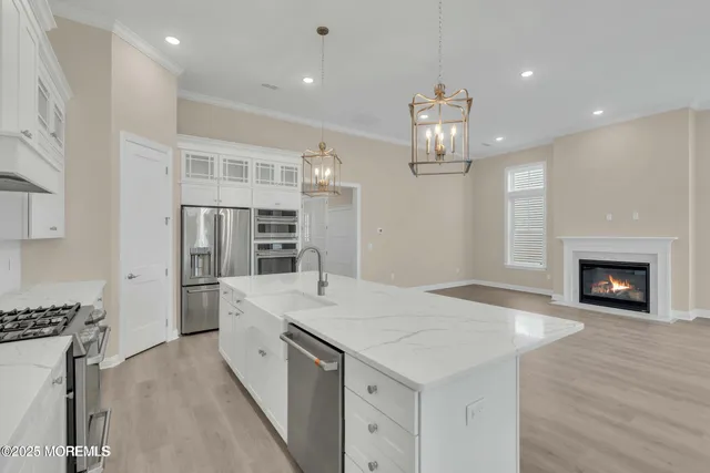 a view of a kitchen with refrigerator and fireplace