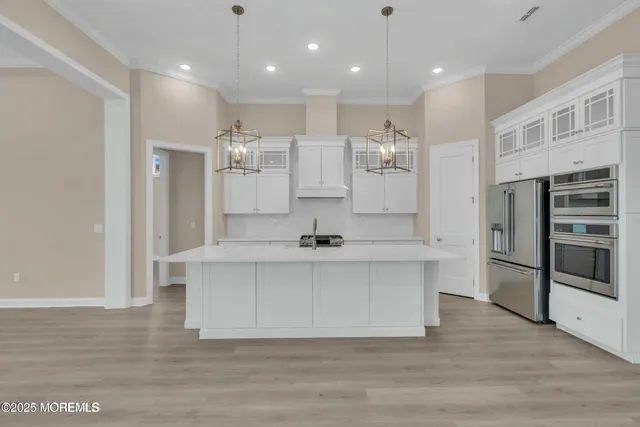 a view of kitchen with center island and stainless steel appliances