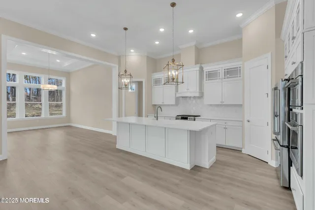 a kitchen with stainless steel appliances a sink stove and refrigerator