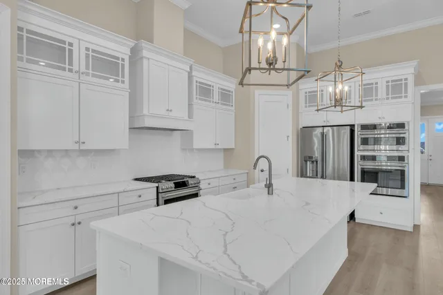 a kitchen with stainless steel appliances a stove sink and cabinets