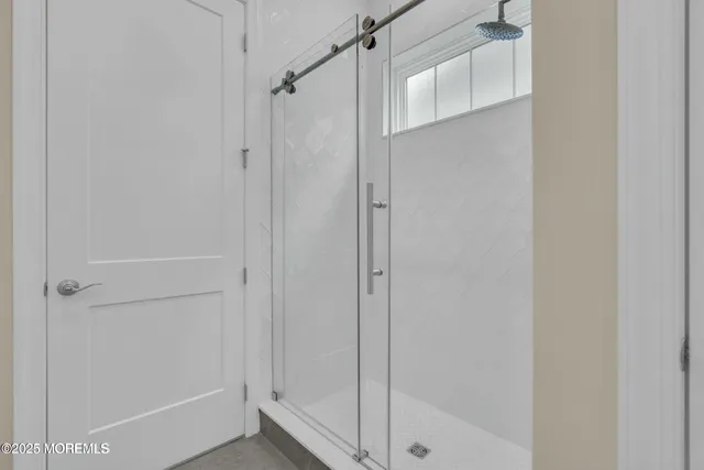 a bathroom with a glass shower door