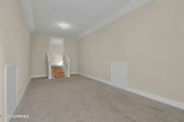 a view of empty room with white walls