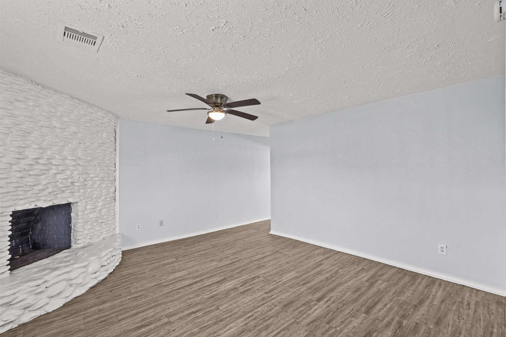 228 Orange Street La Marque, TX 77568 - Photo 3 of 21 a view of empty room with wooden floor and fireplace